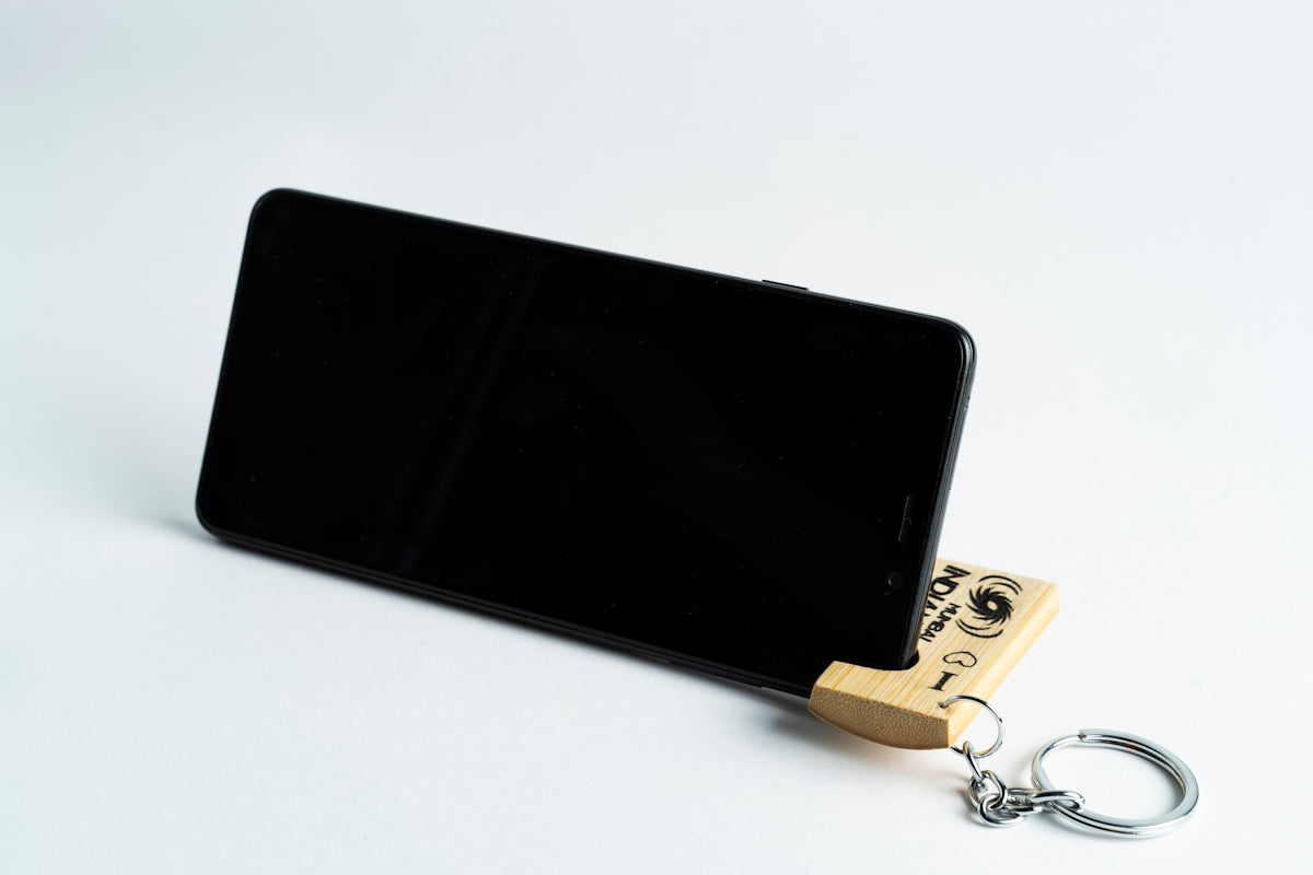 black android smartphone beside gold key