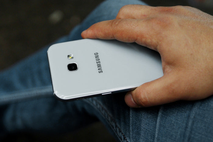 person holding white huawei android smartphone