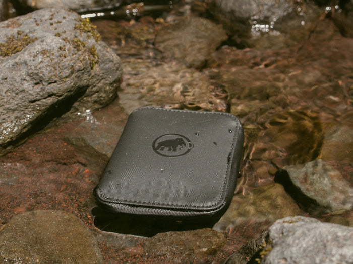 A cell phone laying on top of a rock