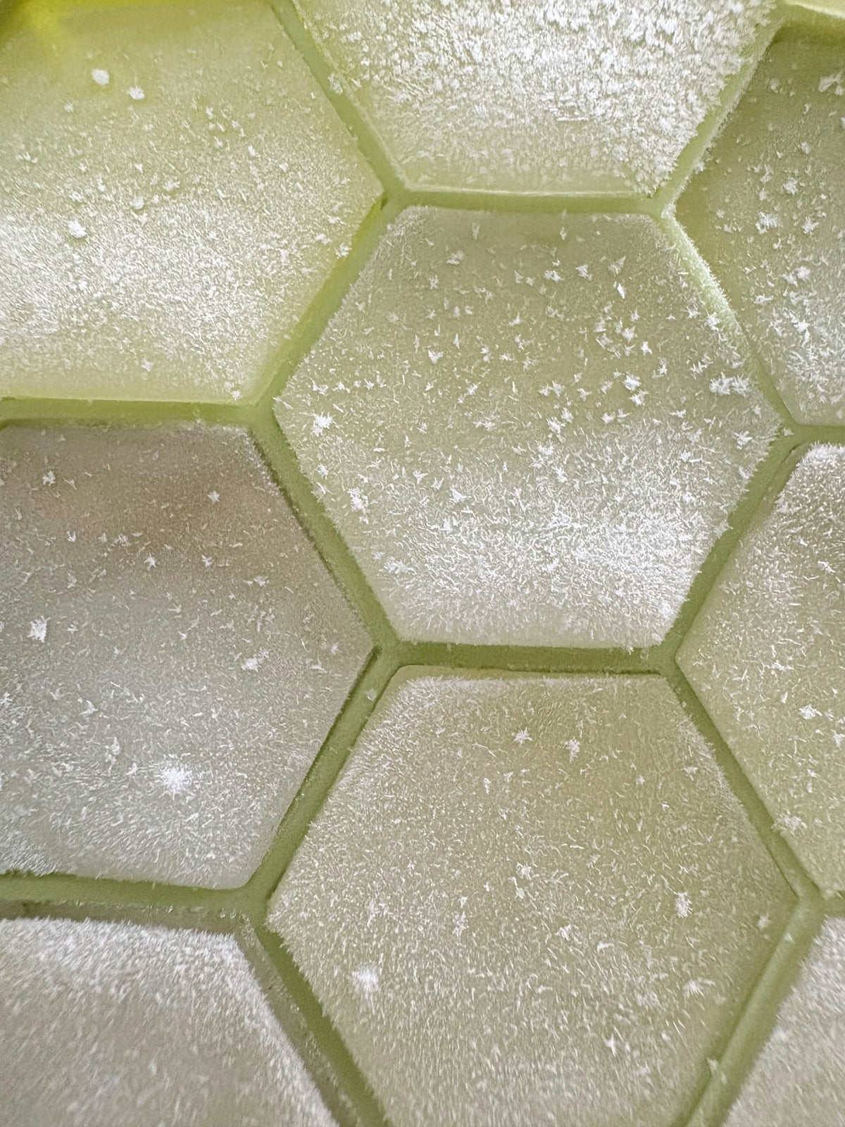 Close-up of frosted hexagonal shapes in a grid.