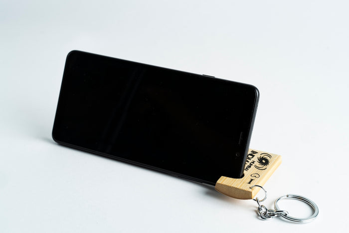 black android smartphone beside gold key