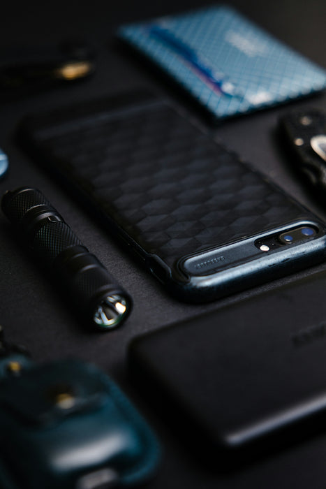 black smartphone on black surface