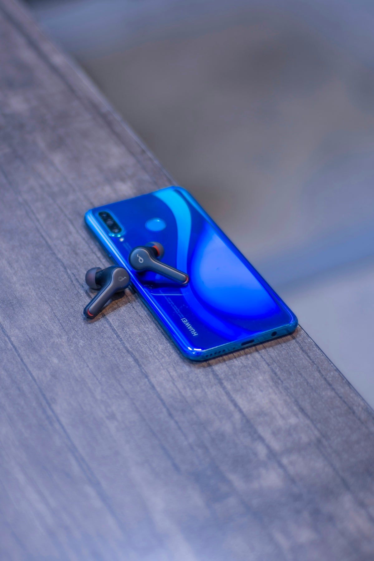 blue iphone case on brown wooden table