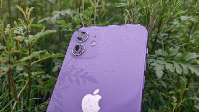 purple iphone case on green grass