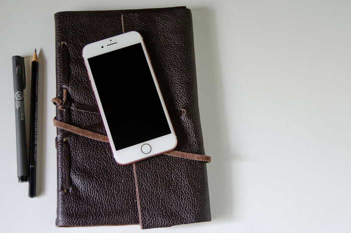 silver iphone 5s on black leather case