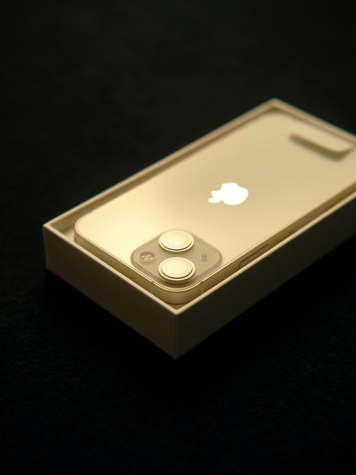 a white iphone sitting on top of a table