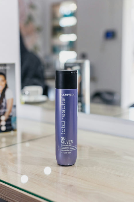 a bottle of hair product sitting on a counter