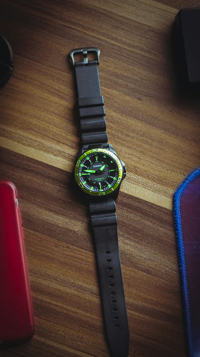 a watch sitting on top of a wooden table