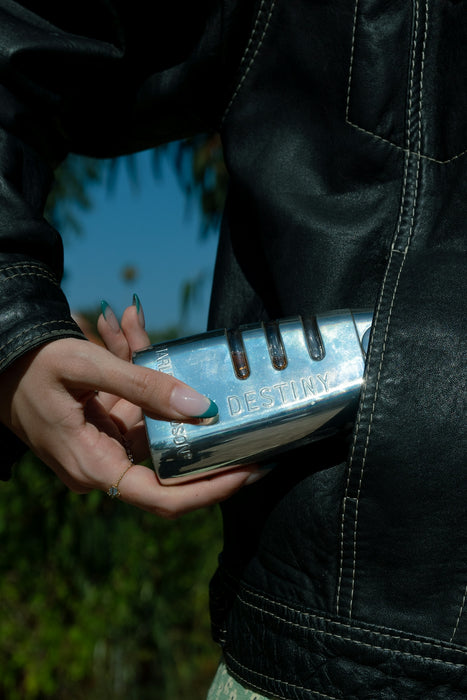 a woman in a black leather jacket holding a cell phone