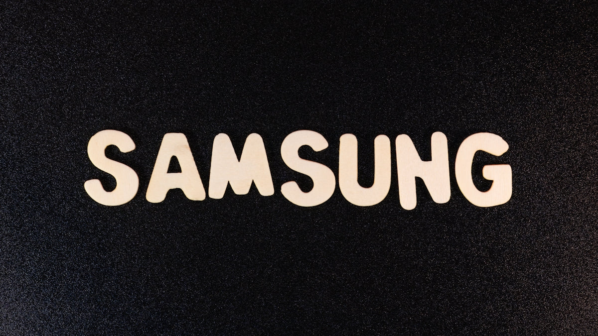 a close up of a samsung logo on a black surface