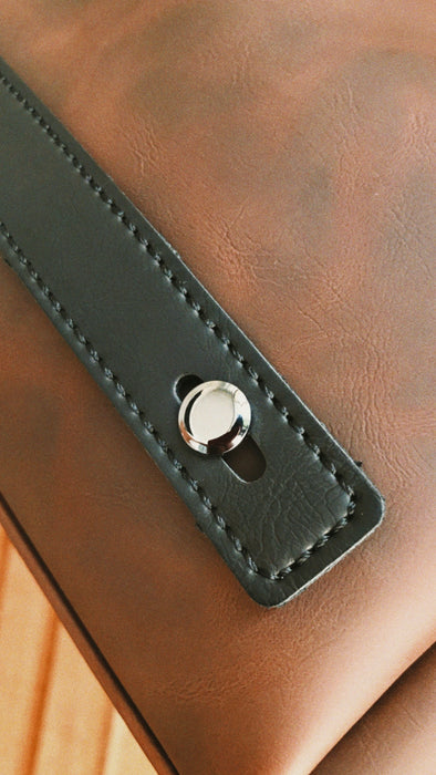 a close up of a brown leather chair