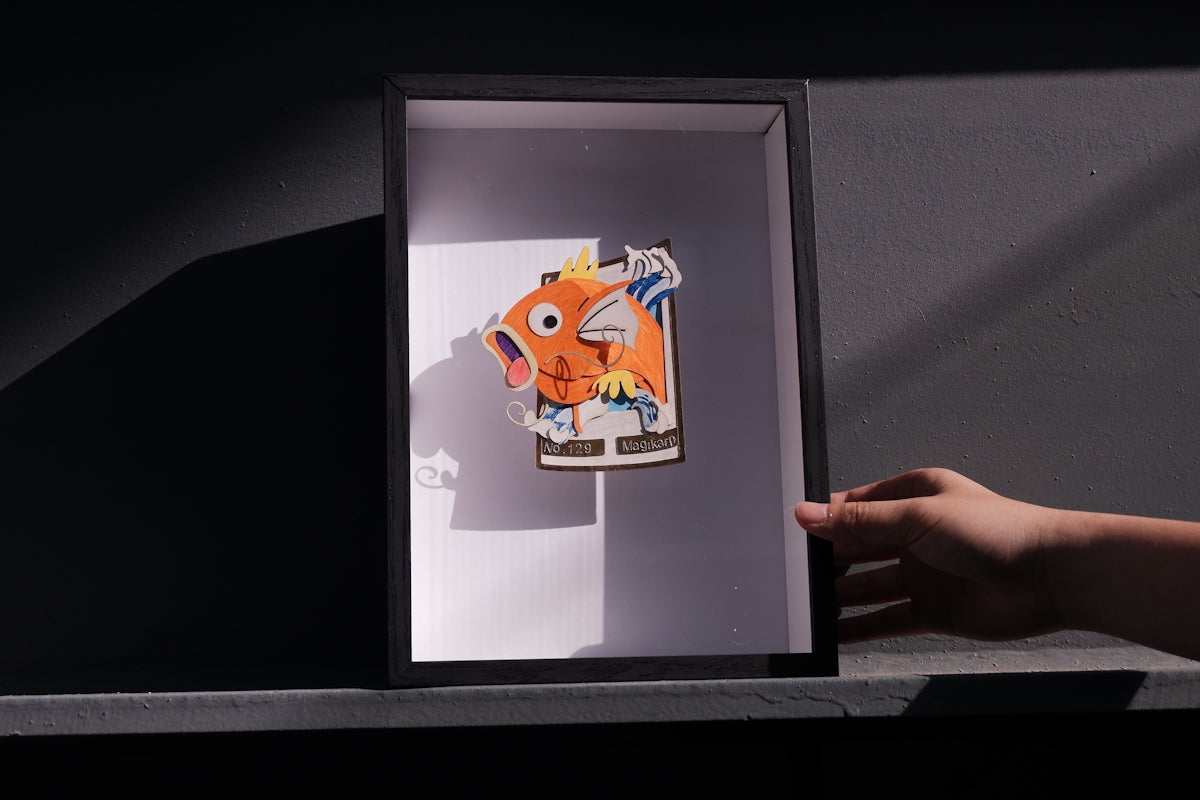 a picture of a hand holding a picture of a fish