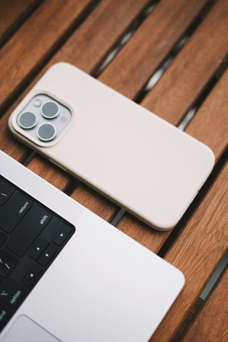 A white cell phone sitting on top of a wooden table
