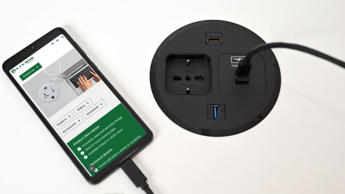 A smart phone plugged into a power strip