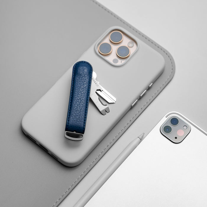 A cell phone with a blue case and a silver case
