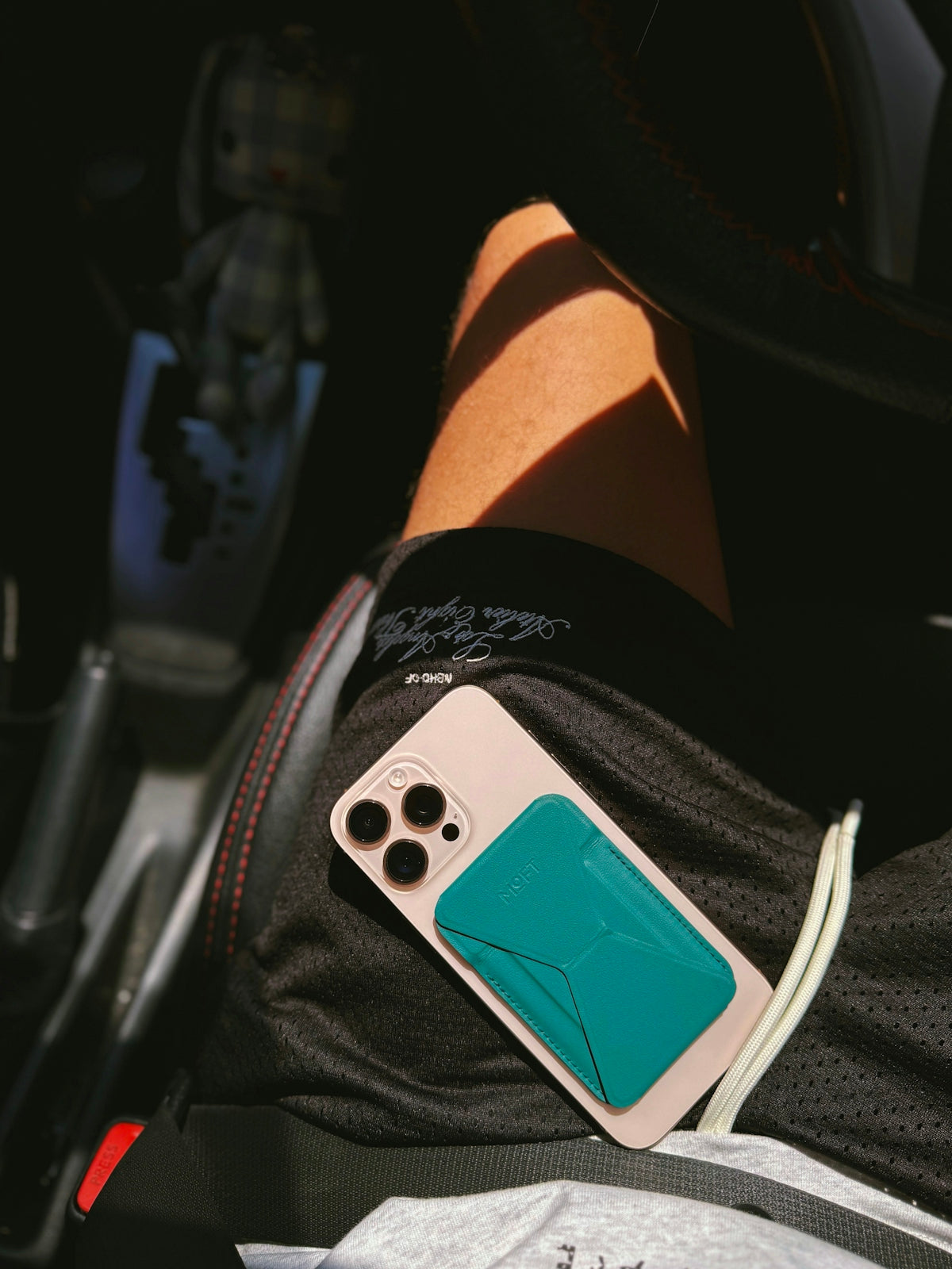 A person sitting in a car holding a cell phone