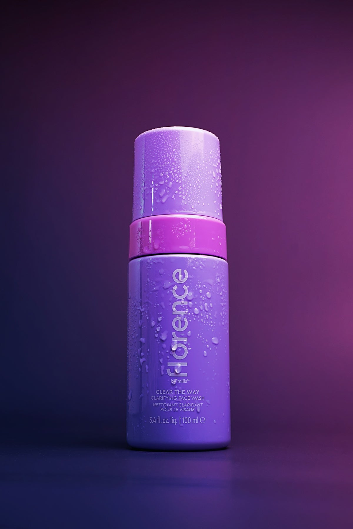 A bottle of deodorant on a purple background