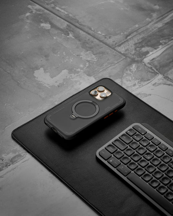 Smartphone, keyboard, and accessories on a desk
