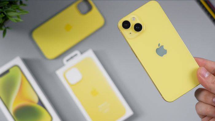 Yellow iPhone with protective cases and packaging