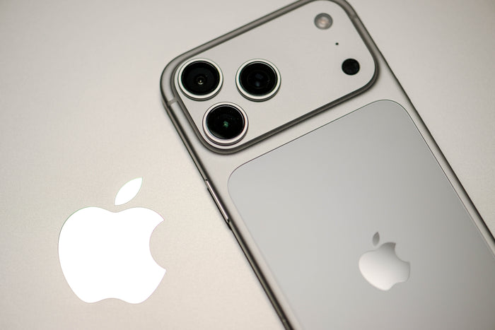 Close-up of a silver iPhone with apple logo.