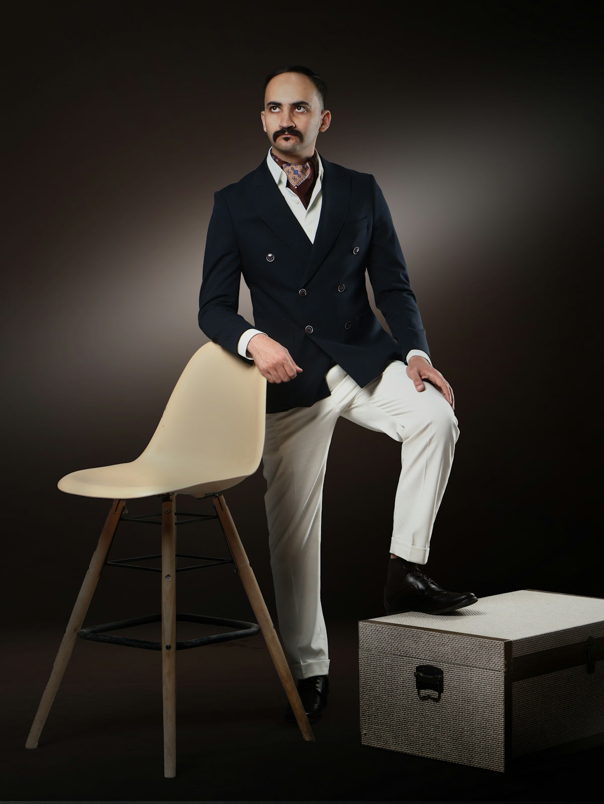 Man in a double-breasted blazer and white pants