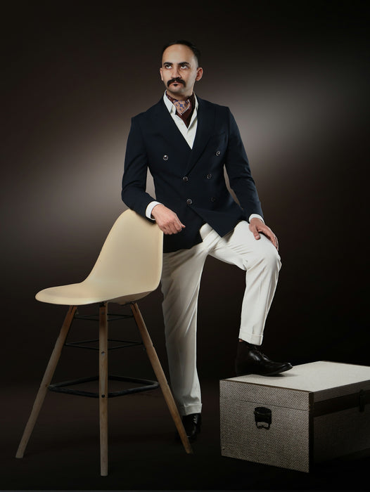 Man in a double-breasted blazer and white pants
