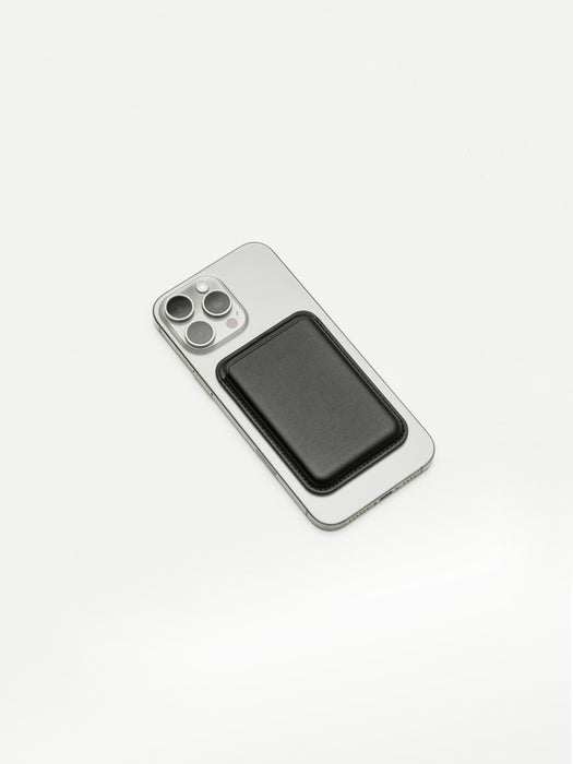 Silver smartphone with black magnetic wallet on a white background.