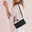 For iPhone 17 Skin Feel Heart Embossed Leather Phone Case with Long Lanyard(Black)