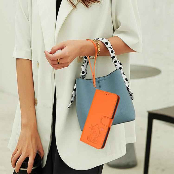 For Samsung Galaxy S25+ / S24+ 5G Embossed Heart Cat Leather Phone Case with Hand Strap(Orange)